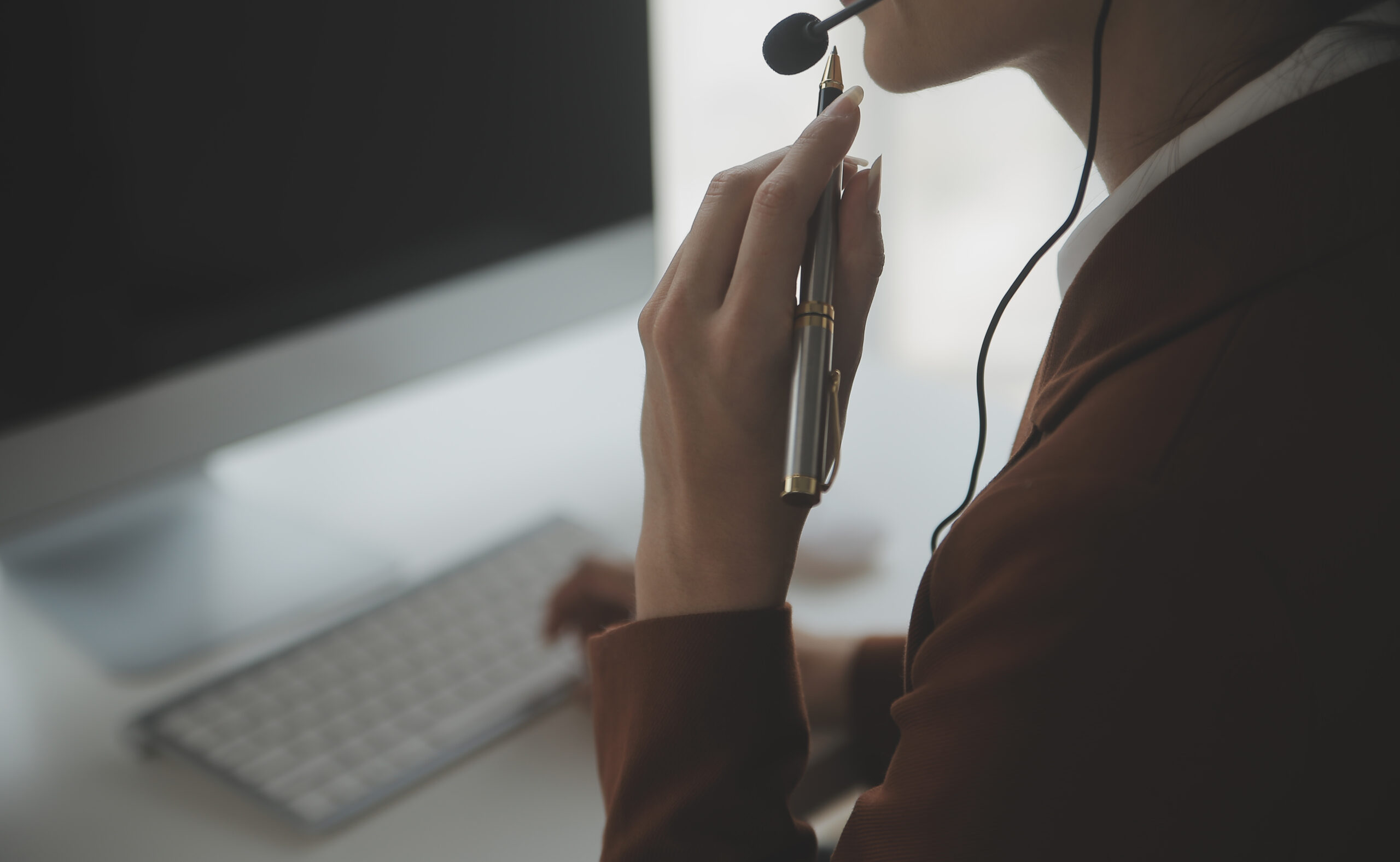 Customer service representative with curly hair talking through headset