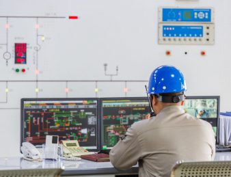 workers in control room of a factory.